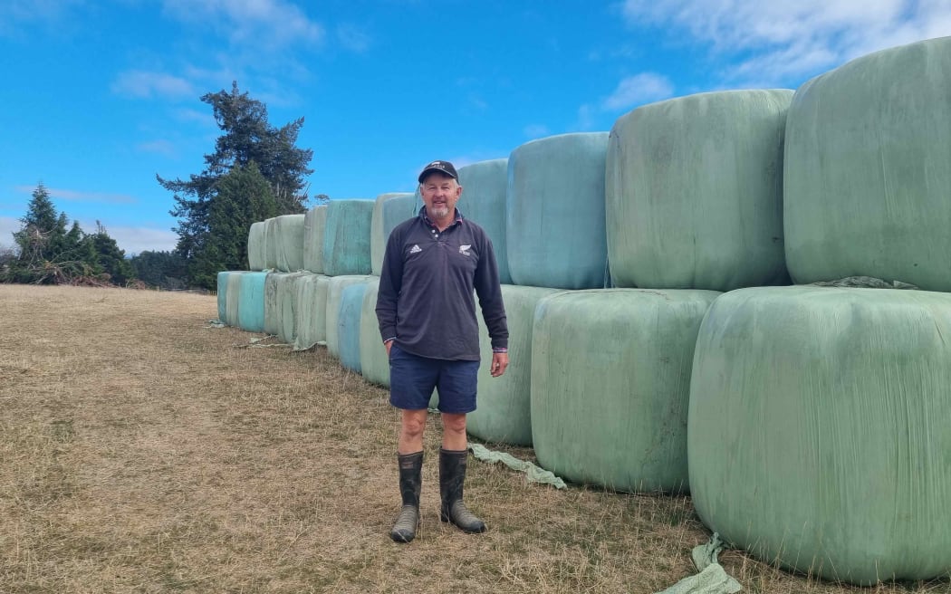 Farmer Peter Moore with some of the baleage he has had to buy in as the drought continues in the Tasman District.