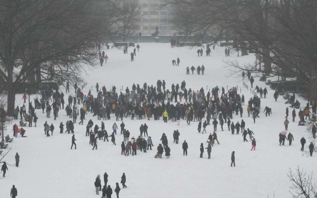 People participate in a snowball fight in Meridian Hill Park in Washington, DC, on January 25, 2026. A massive winter storm on January 24 dumped snow and freezing rain from New Mexico to North Carolina as it swept across the United States towards the northeast, threatening tens of millions of Americans with blackouts, transportation chaos and bone-chilling cold.