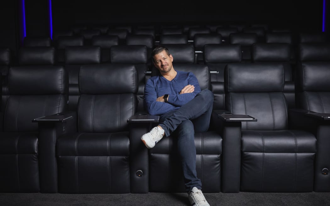 Photo shows a portrait of Silky Otter chief executive Neil Lambert, who is sitting in the cinema.