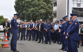 Police officers gather for a minute's silence to remember their colleague Senior Sergeant Lyn Fleming, who died after being struck by a vehicle while patrolling in central Nelson in the early hours of New Years Day.