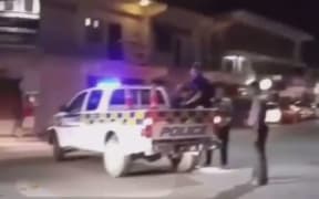 The man in the back of the truck with the police officer in Tonga