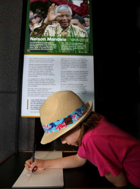Aimee Chandler, 7, signs the remembrance book at Te Papa.