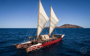 The Haunui, a double-hulled voyaging waka, out on the open waters.