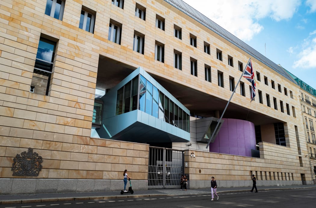 Pedestrians pass in front of the British Embassy in Berlin on August 11, 2021.