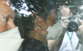 Novak Djokovic wears a face mask as he arrives at the lawyer's office in Melbourne on 16 January 2022.