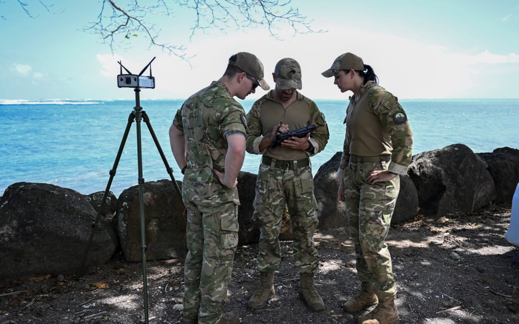 RNZAF Security Force get ready to fly a drone to survey the wreck site of HMNZS Manawanui off the Southern Coast of Upulo.