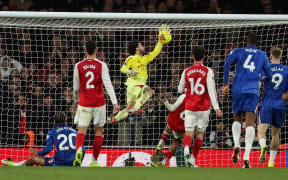 Arsenal's Spanish goalkeeper #01 David Raya (C) makes a save in extra time during the English Premier League football match between Arsenal and Chelsea at the Emirates Stadium in London on March 1, 2026. (Photo by Adrian Dennis / AFP) / RESTRICTED TO EDITORIAL USE. NO USE WITH UNAUTHORIZED AUDIO, VIDEO, DATA, FIXTURE LISTS, CLUB/LEAGUE LOGOS OR 'LIVE' SERVICES. ONLINE IN-MATCH USE LIMITED TO 120 IMAGES. AN ADDITIONAL 40 IMAGES MAY BE USED IN EXTRA TIME. NO VIDEO EMULATION. SOCIAL MEDIA IN-MATCH USE LIMITED TO 120 IMAGES. AN ADDITIONAL 40 IMAGES MAY BE USED IN EXTRA TIME. NO USE IN BETTING PUBLICATIONS, GAMES OR SINGLE CLUB/LEAGUE/PLAYER PUBLICATIONS. /