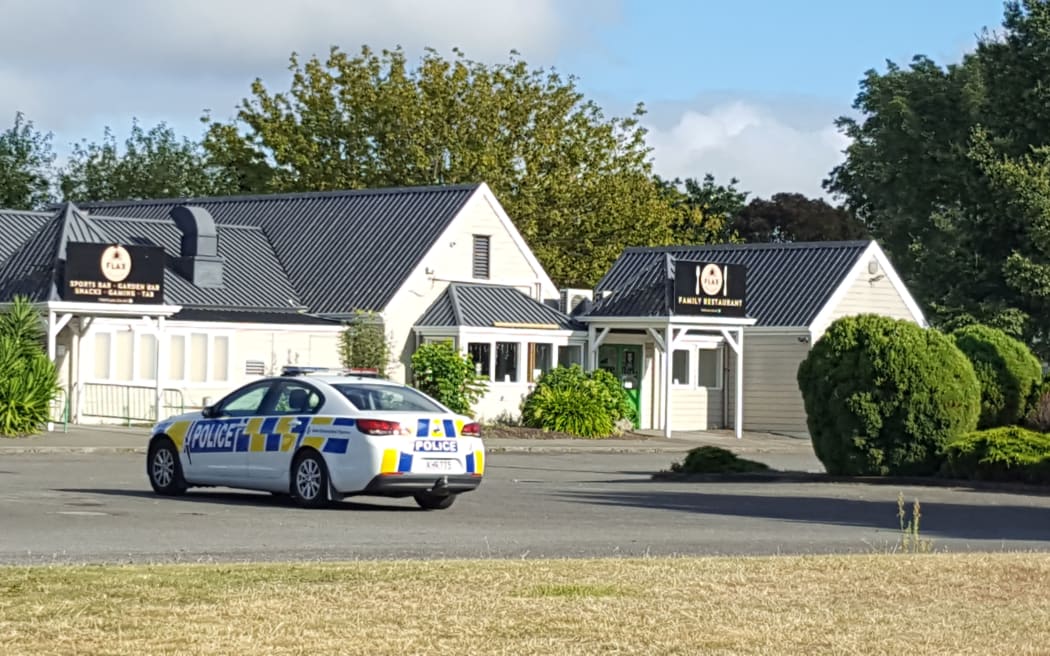 Police outside the Flax Bar and Eatery after a man died outside the building last night.