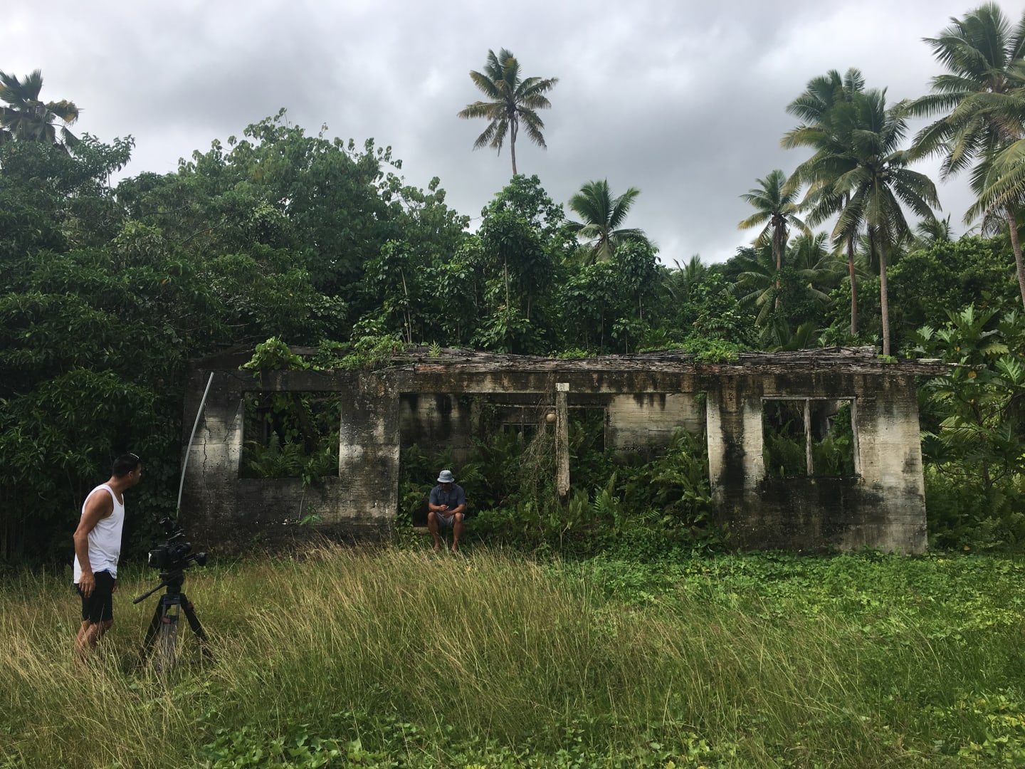 DOP, Jack Tarrant, setting up a shot with presenter, Shimpal Lelisi, in an overgrown derelict Niue building