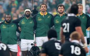 Springboks players stand for the All Blacks haka.