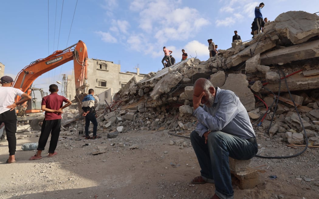 A Palestinian man wait for news of his daughter as rescue workers search for survivors under the rubble of a building hit in an overnight Israeli bombing in c, in the southern Gaza Strip, on April 21, 2024 amid the ongoing conflict between Israel and the Palestinian Islamist group Hamas. (Photo by MOHAMMED ABED / AFP)