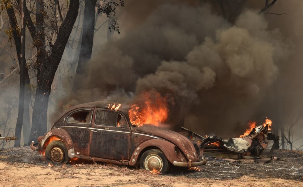 An old car burns from bushfires in Balmoral, 150 kilometres southwest of Sydney on December 19, 2019. -