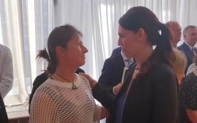Prime Minister Jacinda Ardern shares a moment with Scott Theobold's wife Adriana at the public service awards at Parliament.