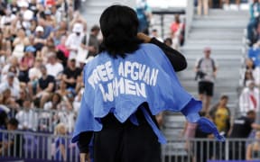 Manizha Talash wears a jacket reading "Free Afghan women" as she competes in the Women's Breaking dance qualifying round of the Paris 2024 Olympic Games at La Concorde in Paris, on August 9, 2024.