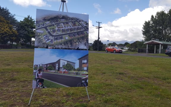 Expectation vs reality. A board displays an artist render of the Marfell KiwiBuild project.