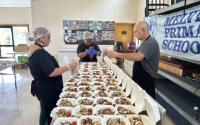 The kitchen staff are preparing food for Melville Primary School pupils.