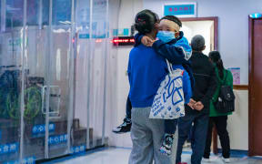 Parents with children who are suffering from respiratory diseases are lining up at a children's hospital in Chongqing, China, on November 23, 2023. (Photo by Costfoto/NurPhoto) (Photo by CFOTO / NurPhoto / NurPhoto via AFP)