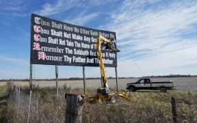 FILE - Workers repaint a Ten Commandments billboard off of Interstate 71 on Election Day near Chenoweth, Ohio, Tuesday, Nov. 7, 2023. Louisiana has become the first state to require that the Ten Commandments be displayed in every public school classroom under a bill signed into law by Republican Gov. Jeff Landry on Wednesday. (AP Photo/Carolyn Kaster, File)
