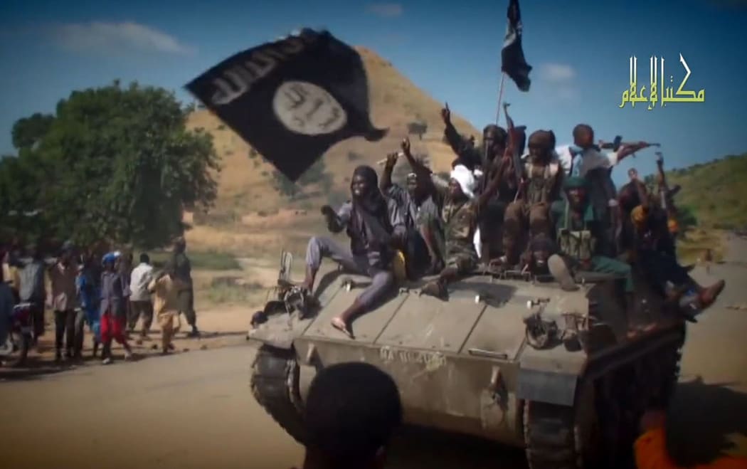 A screengrab taken on November 9, 2014 from a Boko Haram video released by the Nigerian Islamist extremist group Boko Haram and obtained by AFP shows Boko Haram fighters on a tank parading in an unidentified town.