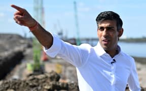 Conservative MP and Britain's former Chancellor of the Exchequer, Rishi Sunak gestures as he talks with Tees Valley Mayor Ben Houchen (unsen) during a visit to see the construction works at Teesside Freeport in Redcar, north East England on July 16, 2022, as part of his bid to become the next leader of the Conservative party. - Britain's Prime Minister, and leader of the ruling Conservative party Boris Johnson last week announced his resignation as Tory leader after a cabinet insurrection, following months of controversies. (Photo by Oli SCARFF / AFP)
