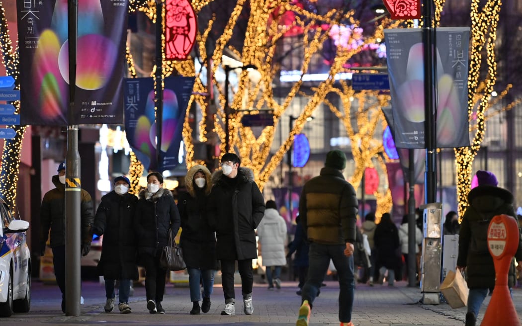 People visit a shopping district on New Year's Eve in Seoul on December 31, 2020. (Photo by Jung Yeon-je / AFP)