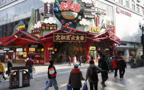 WUHAN, CHINA - DECEMBER 30: People walk at the street of Wuhan city where coronavirus (Covid-19) first discovered and spread all around the world, on December 30, 2021 in China. Emre Aytekin / Anadolu Agency (Photo by Emre Aytekin / ANADOLU AGENCY / Anadolu Agency via AFP)