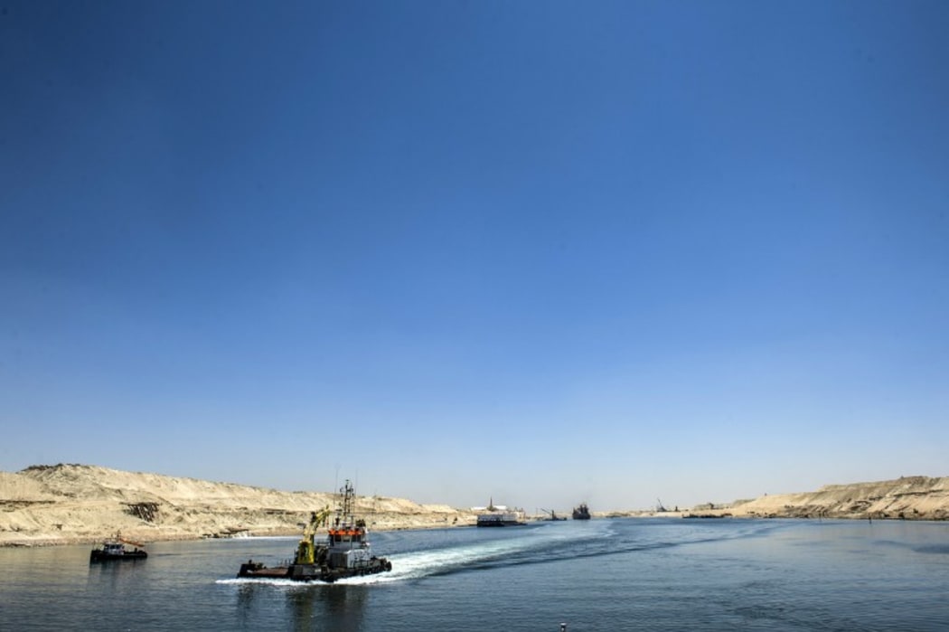 A picture taken on July 29, 2015 shows boats crossing the new waterway at the new Suez Canal in the Egyptian port city of Ismailia, east of Cairo.