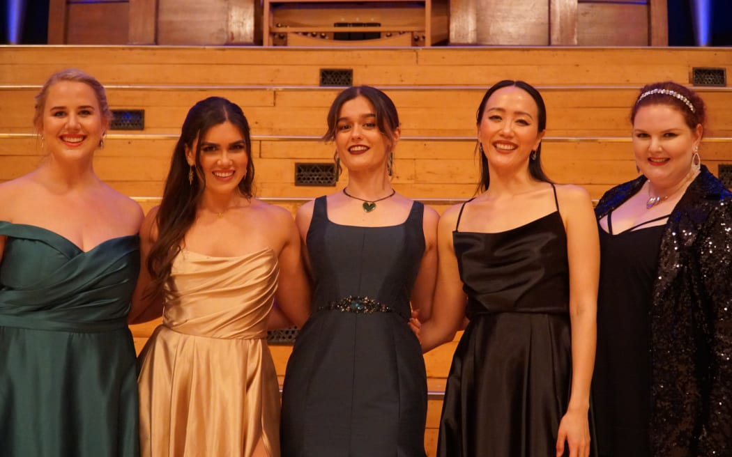 Opera singers Eliza Boom, Amelia Berry, Natasha Wilson, Christina Orjis and pianist Somi Kim gather after the Auckland Opera Studio Gala Concert 2022.