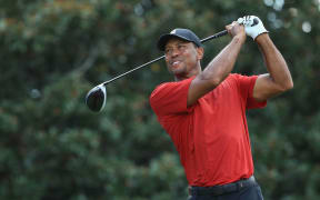 Tiger Woods plays his shot from the 14th tee during the final round of the Tour Championship in Atlanta.