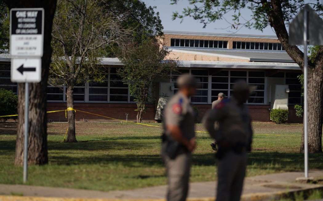 Officers stand outside Robb Elementary School in Uvalde, Texas, on May 25, 2022 where children and teachers were killed in a shooting.