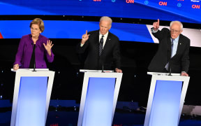Democratic presidential hopefuls Massachusetts Senator Elizabeth Warren (L), former Vice President Joe Biden (C) and Vermont Senator Bernie Sanders participate of the seventh Democratic primary debate of the 2020 presidential campaign season.