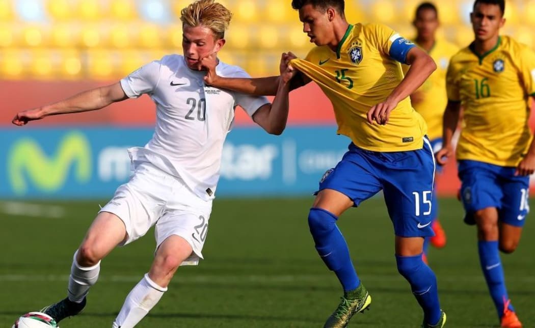 New Zealand striker Lucas Imrie battles for possession against Brazil at the under 17 World Cup.