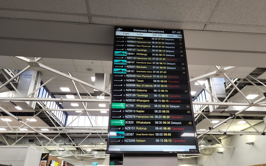 The departure board at Auckland Airport showing flights delayed and cancelled due to fog