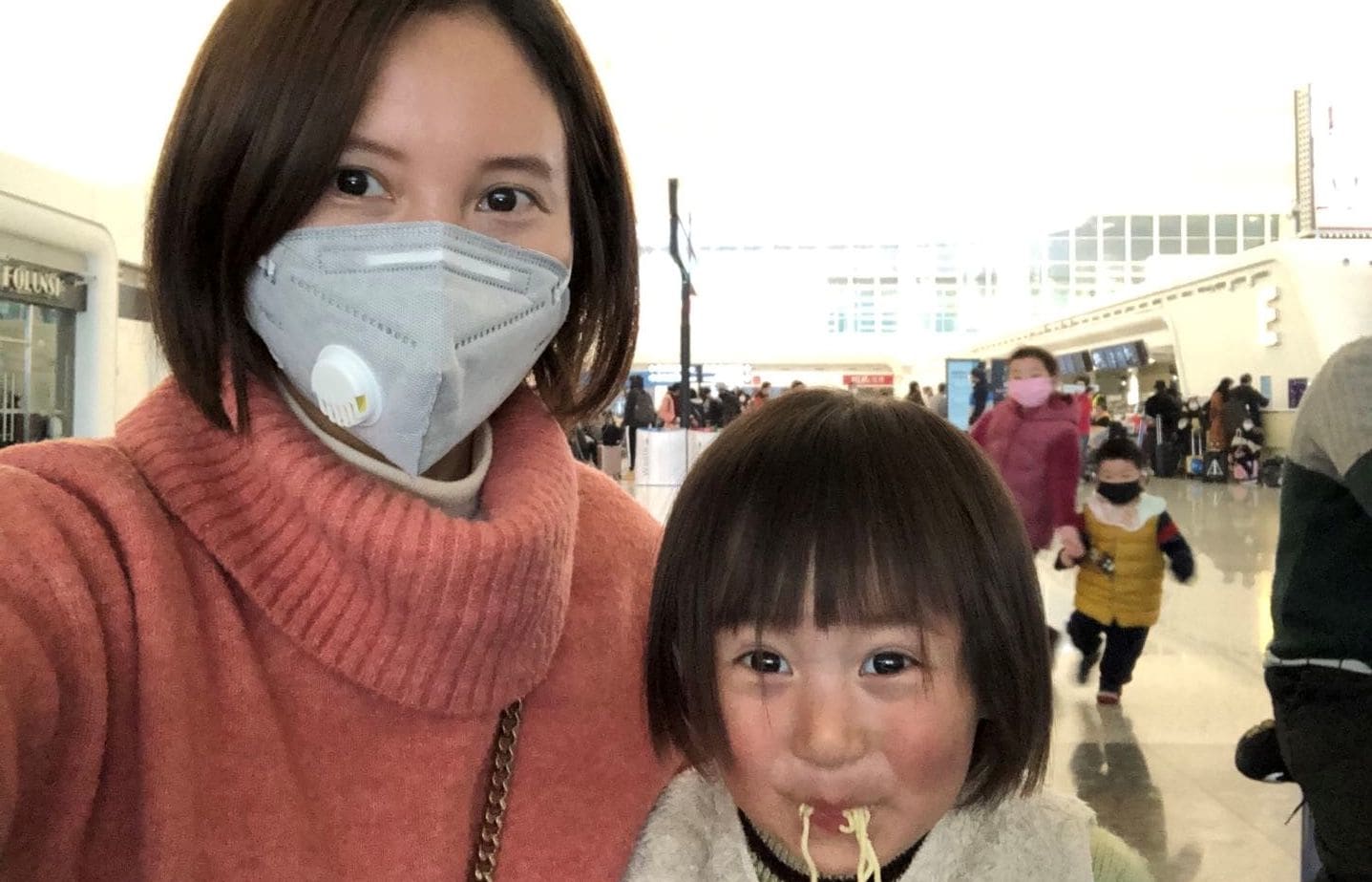 Lily Gao and her two-year-old daughter Elysse at the Wuhan airport, waiting to be evacuated by a government-chartered flight.