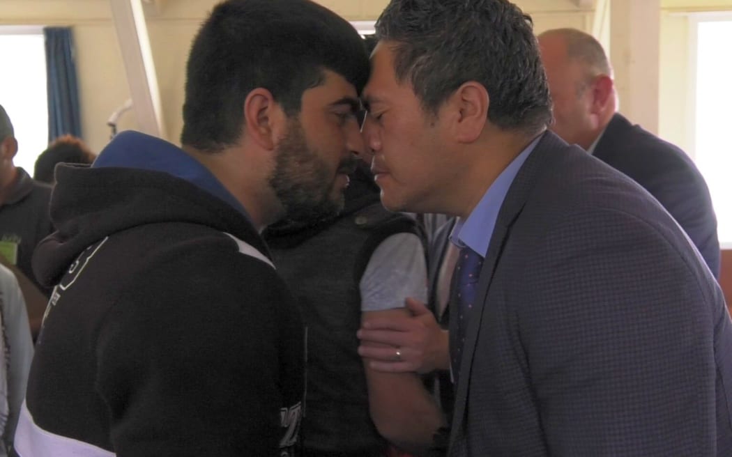 A refugee is welcomed to New Zealand with a hongi