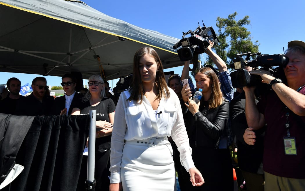 Australian former political staffer Brittany Higgins (C) at a rally to address protesters against sexual violence and gender inequality in front of Parliament House in Australia's capital city Canberra on 15 March 2021.
