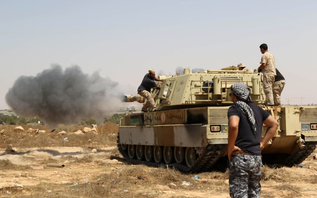 Libyan unity government forces fire from a tank in Sirte towards Ouagadougou.