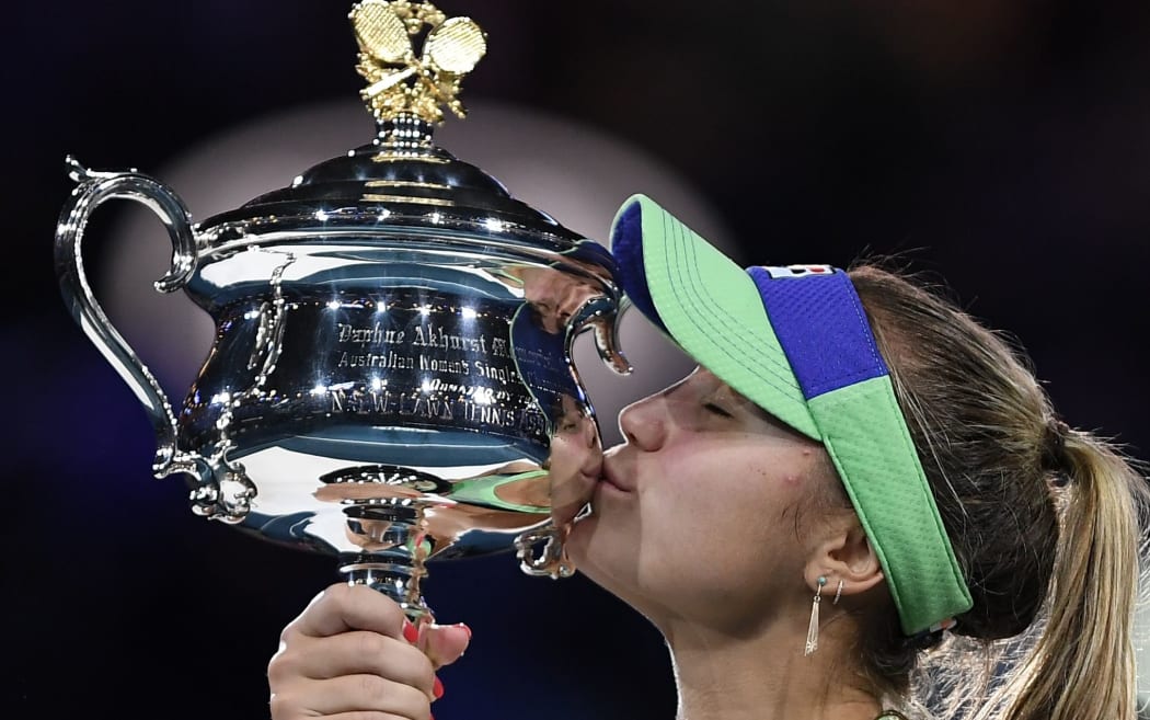 Sofia Kenin of the US kisses the Daphne Akhurst Memorial Cup after winning against Spain's Garbine Muguruza in their women's singles final match  Australian Open tennis tournament in Melbourne on February 1, 2020.