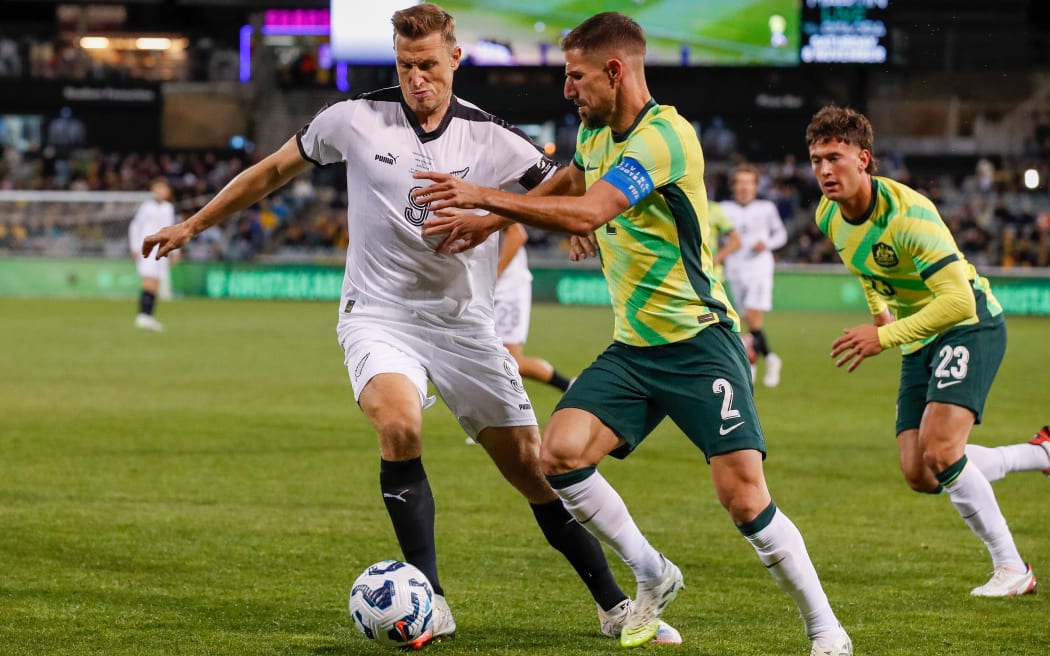 Chris Wood and Milos Degenek compete for the ball.