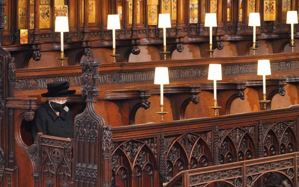 Queen Elizabeth II takes her seat for the funeral service of Britain's Prince Philip, Duke of Edinburgh inside St George's Chapel in Windsor Castle in Windsor, west of London, on April 17, 2021.