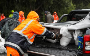 People load up sandbags at Dunedin Ice Stadium.