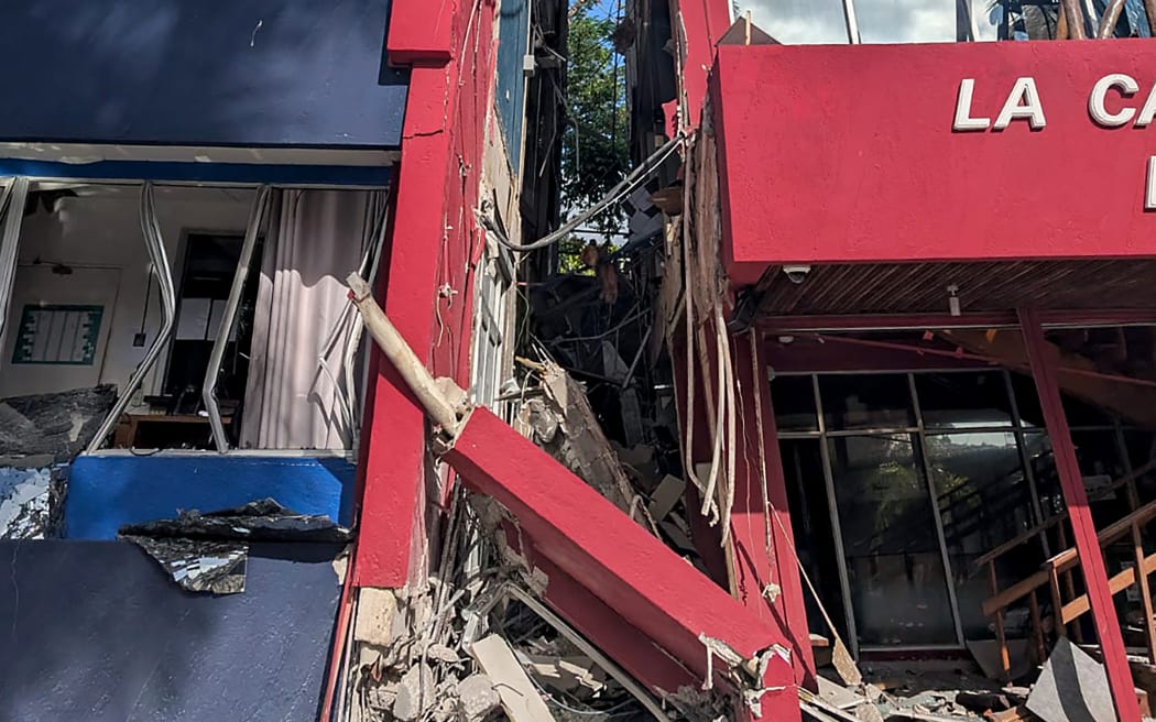 This photo shows a general view of a severely damaged building housing the embassies of the United States, United Kingdom, and New Zealand after a powerful earthquake struck Port Vila, the capital city of Vanuatu, on 17 December 2024.