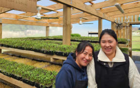 Mother and daughter, Kali and Jiang Yu, in the greenhouse