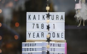 Locals call the Kaikoura earthquake anniversary, one year done. Sign in a retail shop on the main road, West End, Kaikoura.
