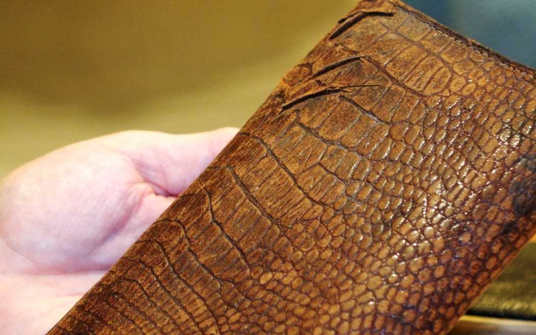 Ted Gasparich's wallet, slashed by shrapnel.