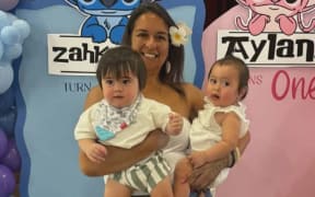 Biddy Tai Ahmu and her twin grandchildren, Aylani and Zahkani.