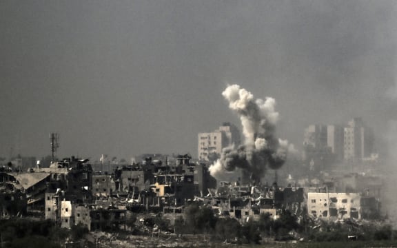 A picture taken from near the southern Israeli city of Sderot on October 28, 2023, shows smoke raising during an Israeli strike in the northern Gaza Strip. Israeli air strikes destroyed hundreds of buildings in the Gaza Strip overnight, the civil defence service in the Hamas-controlled Palestinian territory said on October 28. (Photo by Aris MESSINIS / AFP)