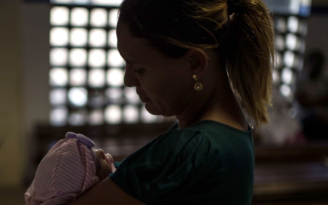 A woman holds her 45-day-old daughter suffering from microcephalia at a hospital in Salvador, Brazil.