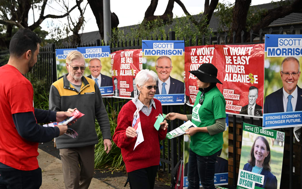 Residents make their way to a polling station to cast their vote at the Australian general elections in Cook electorate of Sydney on May 21, 2022. - Polls opened in Australia's federal election May 21, 2022 , with Prime Minister Scott Morrison fighting for another three-year term that would extend a decade of conservative rule. (Photo by SAEED KHAN / AFP)