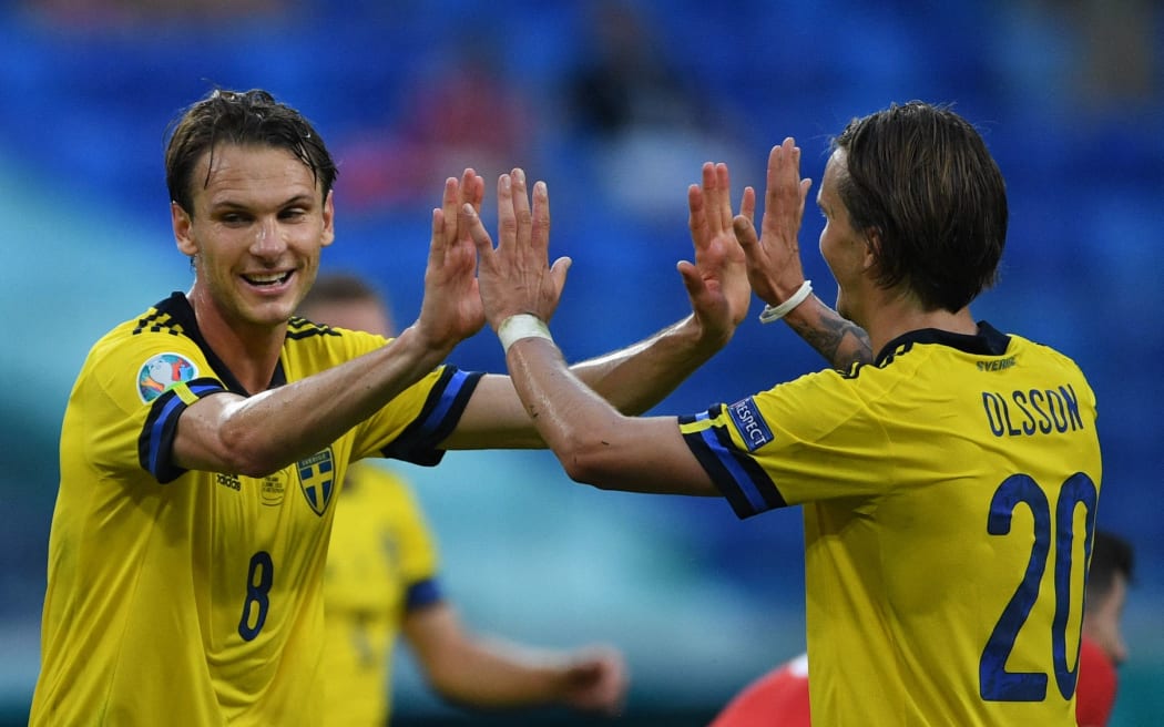 Sweden's Albin Ekdal and Kristoffer Olsson celebrate the victory in the Euro 2020 group stage soccer match against Poland, in Saint Petersburg, Russia.